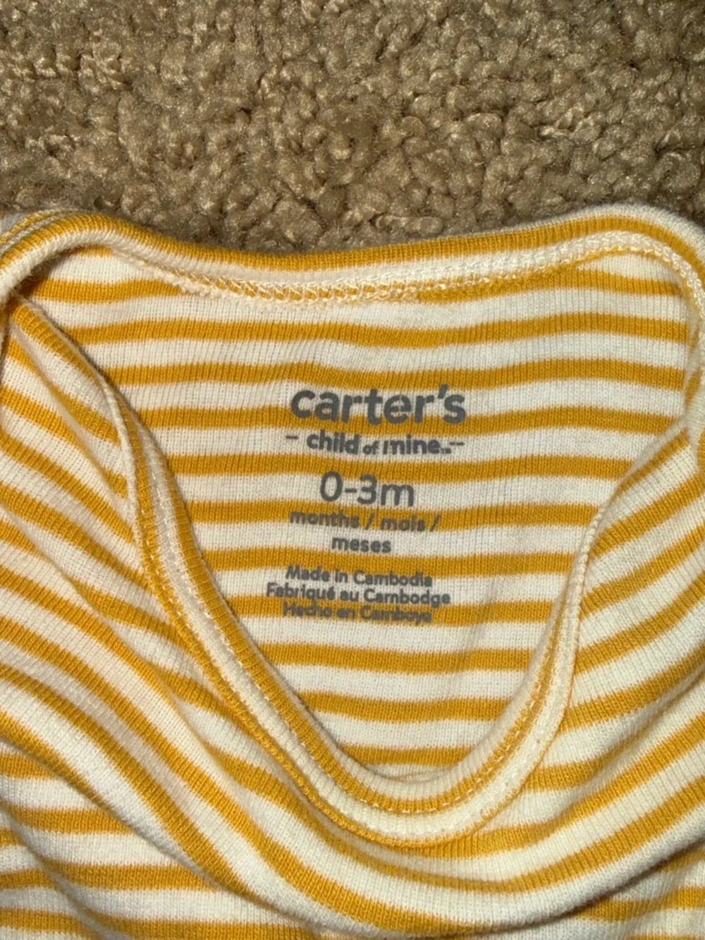 white and yellow striped baby onesies